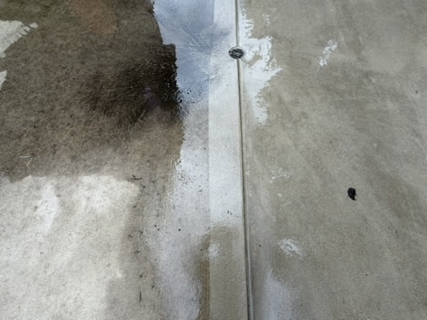 Concrete patio mid-clean showing before and after