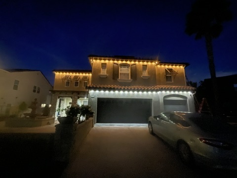 Warm white Govee permanent lights on a home at dusk