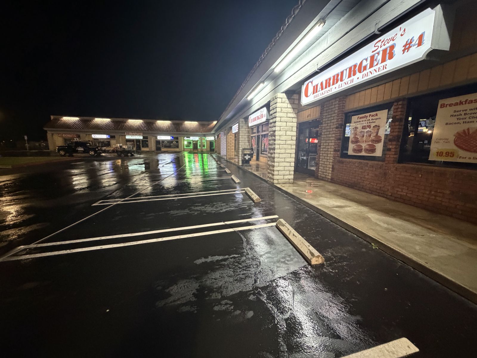 Restaurant storefront and parking area cleaned at night