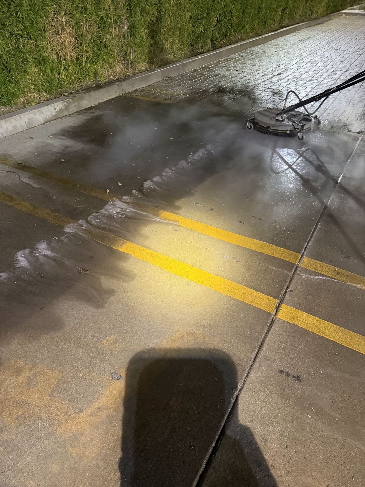 Parking lot cleaning with a surface cleaner on striped concrete