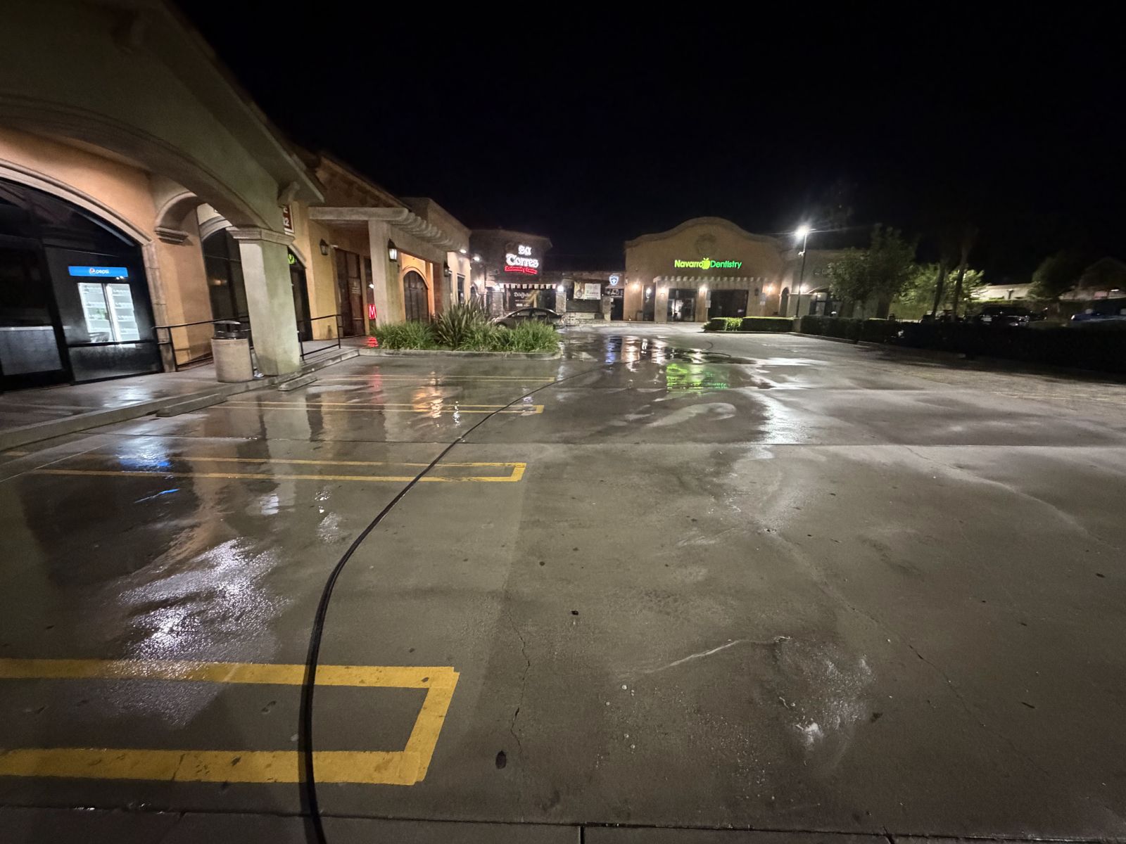 Shopping center parking lot after overnight pressure washing