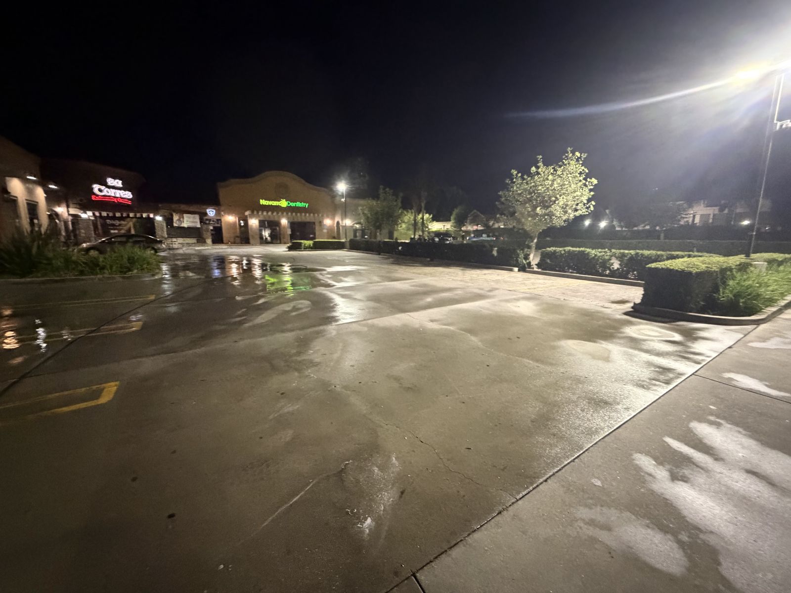 Retail plaza parking lot after overnight pressure washing
