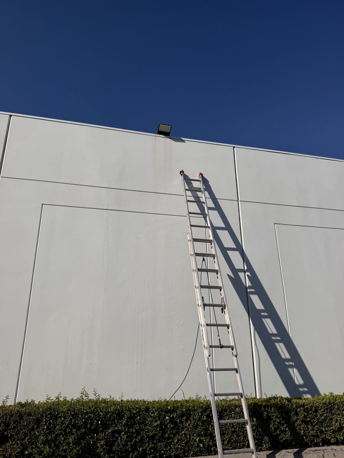 Pre-paint surface preparation on a commercial tilt-up wall