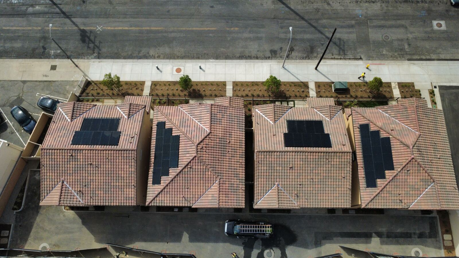 Aerial view of community rooftops with solar panels