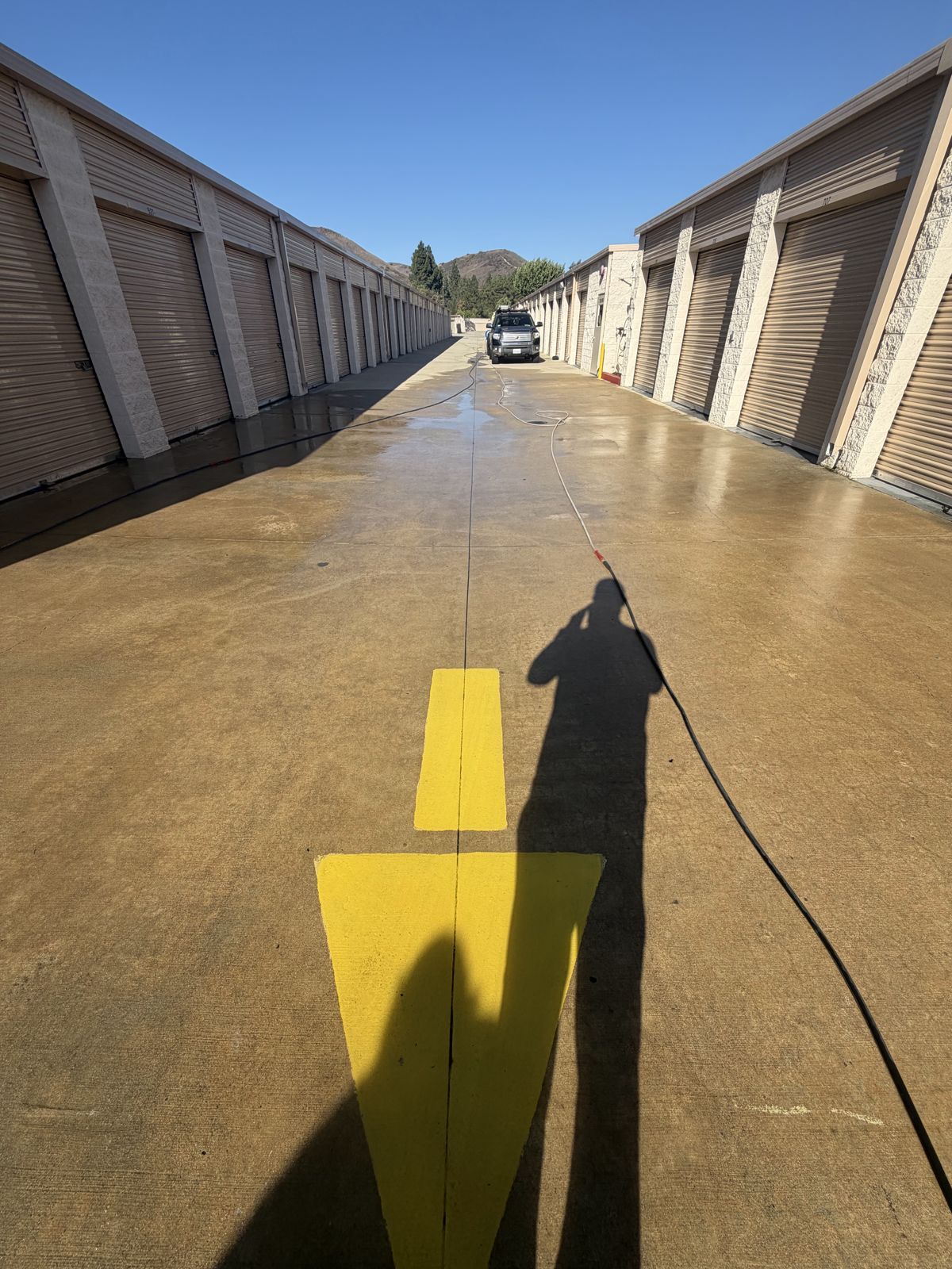 Self-storage drive aisle with wet concrete after cleaning