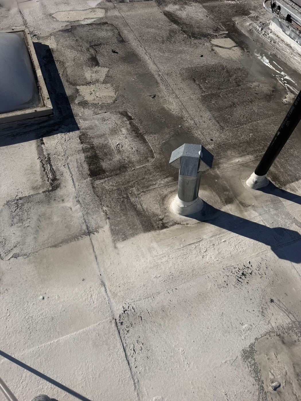 TPO roof membrane being cleaned around rooftop vents