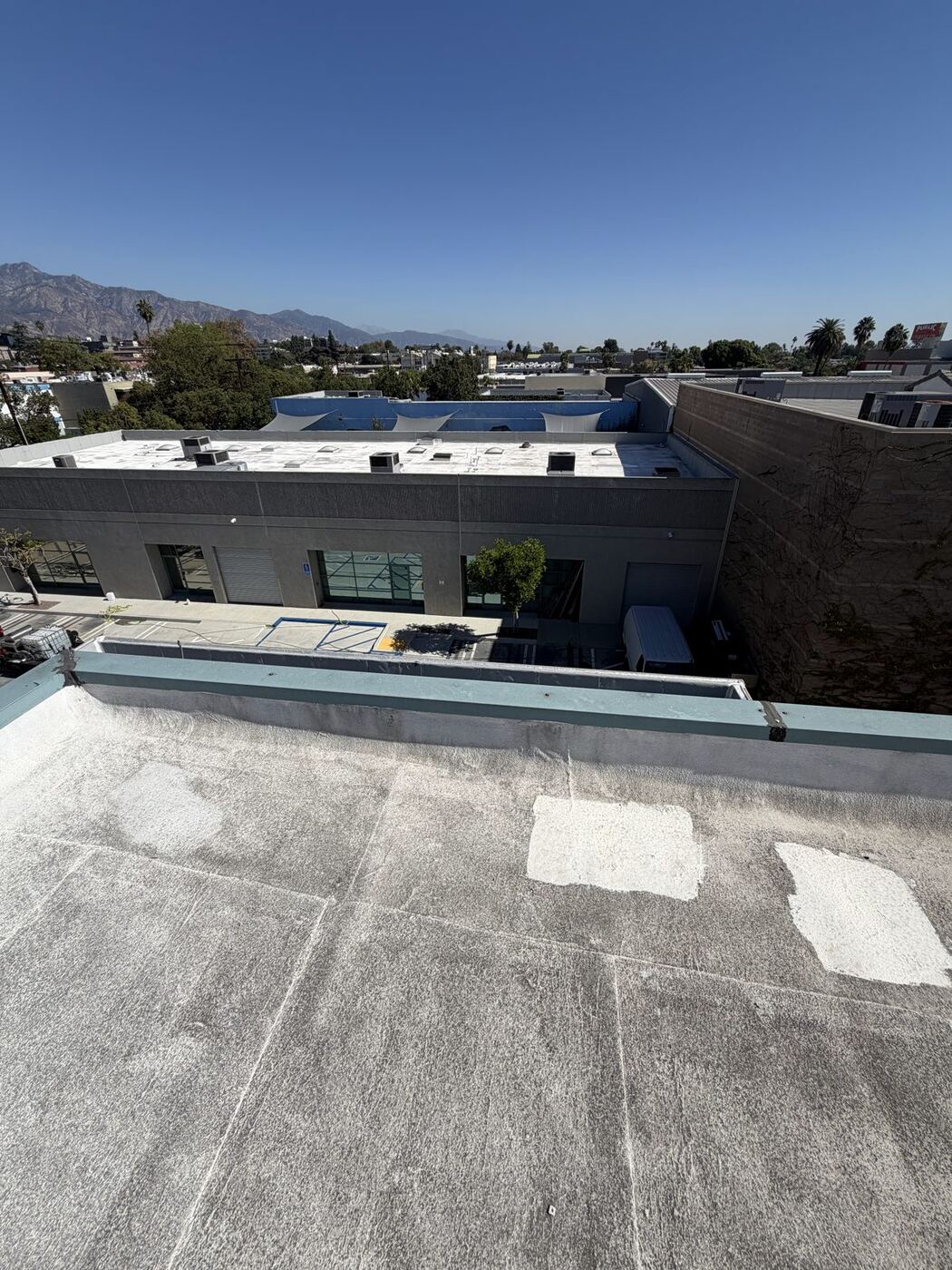 Clean test patches on a dirty commercial TPO roof